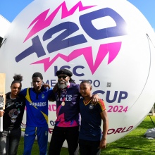 Chris Gayle of the West Indies poses with young Barbados cricketers