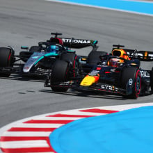 Max Verstappen of the Netherlands driving the Oracle Red Bull Racing RB20 overtakes George Russell