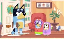 Bandit holding a clipboard while Bluey and Bingo are dressed as grannies in 'Bluey.'