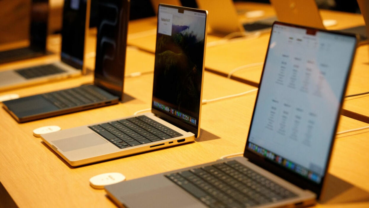 MacBooks in a row on display at a store