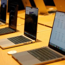 MacBooks in a row on display at a store