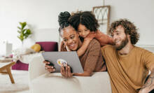 A family looking at a device