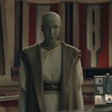 Vernestra Rwoh, a bald, green humanoid alien, in the Jedi Temple.