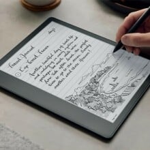someone writes notes on a kindle scribe with a pen