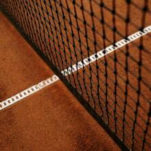 Tennis net on clay court