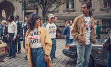 Lydia West as Jill Baxter and Nathaniel Curtis as Ash Mukherjee wearing T Shirts with the slogan "AIDS needs AID!"