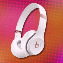 Beats Solo 4 on orange and pink abstract background