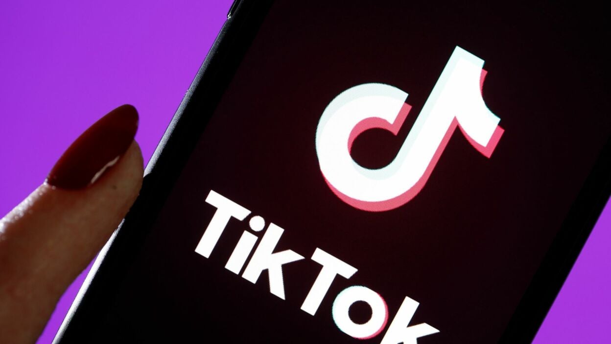 In this photo illustration, the TikTok logo is displayed on the screen of an iPhone.