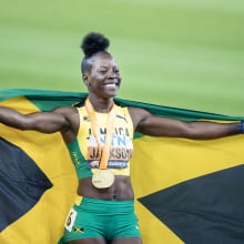 Shericka Jackson shows off a gold medal