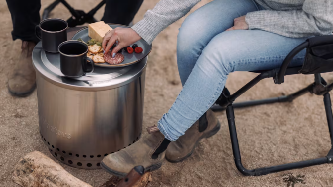 campers sit around the Solo Stove and have snacks