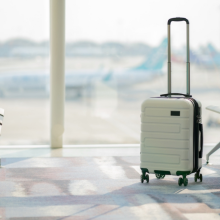 The suitcases in an empty airport hall, traveler cases in the departure airport terminal waiting for the area, vacation concept, blank space for text message or design