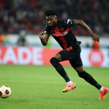 Edmond Tapsoba of Bayer Leverkusen runs with a ball