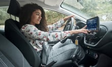 woman touching car smart display