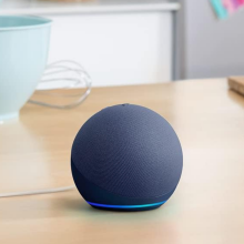 An Amazon Echo Dot on a kitchen counter