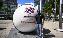 USA Cricket Vice-Captain Aaron Jones poses next to a giant cricket ball