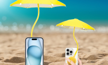 Man holding phone at beach