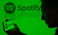 The Spotify logo is being displayed on a smartphone with Spotify visible in the background in this photo illustration in Brussels, Belgium, on May 11, 2024.