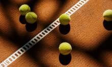 Tennis balls on a clay court