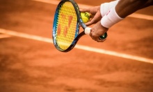 A tennis player about to serve