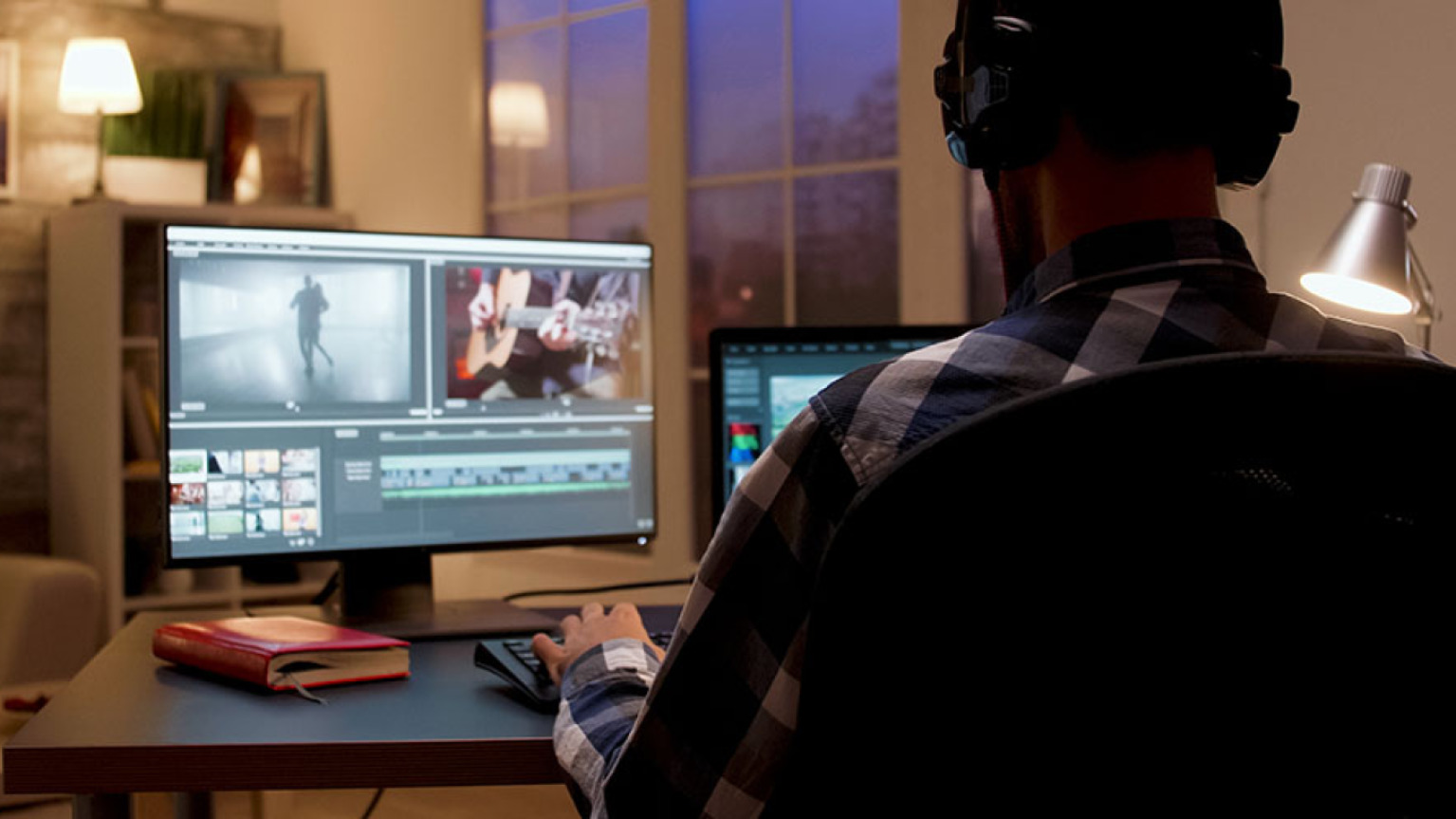 man editing video on his computer