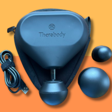 theragun mini with charging cord and additional massage heads 