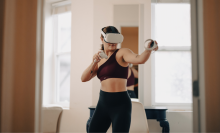 woman in workout clothes wearing VR headset 