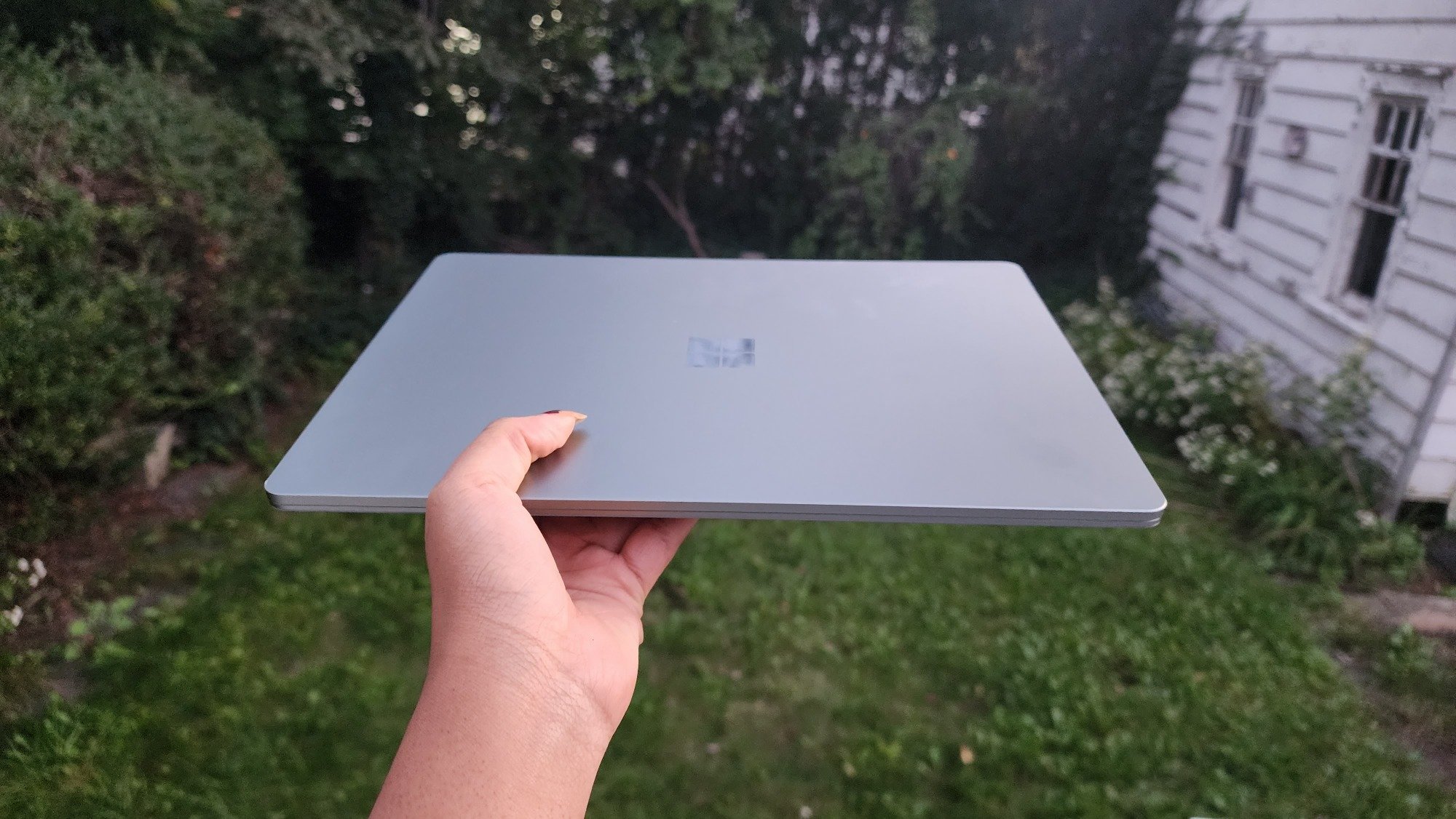 Surface Laptop Go 3 in a garden backyard