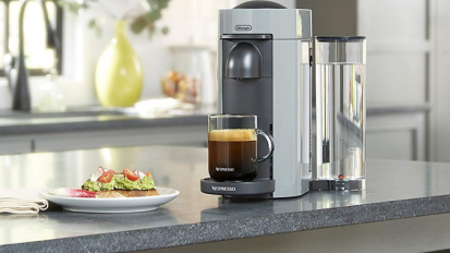 DE'LONGHI personal espresso maker on a kitchen counter.