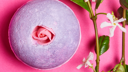 purple lush bath bomb with pink background