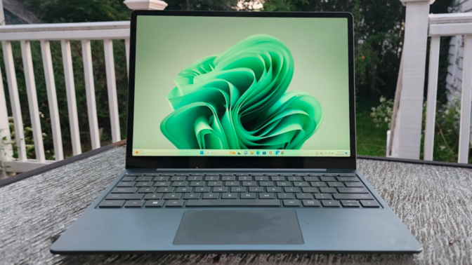 microsoft surface laptop go 3 on a patio table outside on a deck