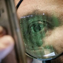 Closeup of a person's eye and face as they look at a smartphone screen. 