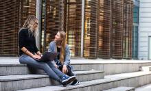 Two people talking on steps