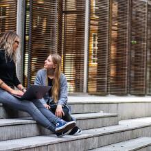 Two people talking on steps