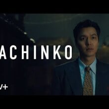 A man in a suit, with the title card "Pachinko" beside him.