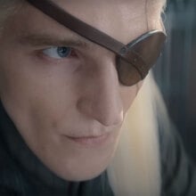 A close-up of a blonde man wearing a leather eyepatch.