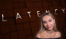 Alexis Ren smiling in front of the film's poster art