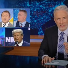 A man sits behind a talk show desk. In the top-left is a collage of images of people on the news.