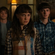 Five of the kids from Netflix's "Stranger Things" series stand in a row, wearing concerned expressions as they stare at something off-camera.