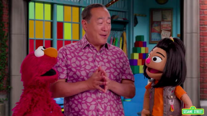 Sesame Street's Elmo, Alan, and Ji-Young go on a special neighborhood tour together.