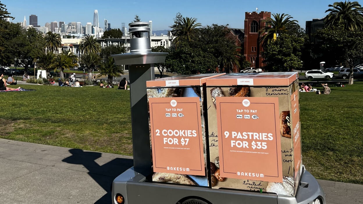 A mobile vending machine with one big wheel selling pastries in front of Dolores Park in San Francisco.