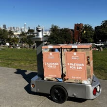 A mobile vending machine with one big wheel selling pastries in front of Dolores Park in San Francisco.