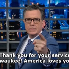 Stephen Colbert on 'The Late Show with Stephen Colbert.' Text on the image reads: "Thank you for your service, Milwaukee! America loves you!"