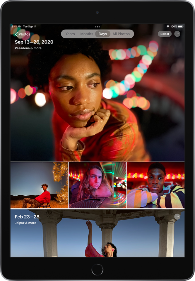 The photo library displayed in Days view. A selection of photo thumbnails fills the screen. In the top left of the screen is the Photos button to open the sidebar. Below the Photos button is the date and location where the photos displayed on the screen were taken. In the top center are options to browse photos by Years, Months, Days, or All Photos; Days is selected. In the top right of the screen are the Select and More Options buttons.