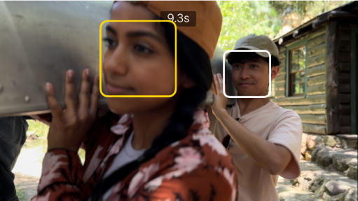 A Cinematic mode clip in the viewer, with a solid yellow box around a face indicating that the focus is locked on that object. A white box appears on an object not in focus.