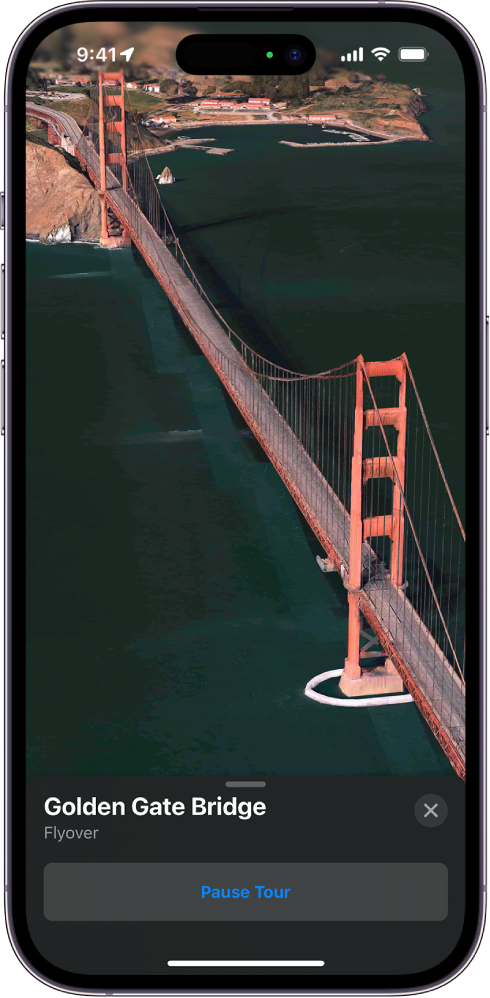 A Flyover tour in progress, showing a 3D image from the sky looking toward a landmark and a button to pause the tour.