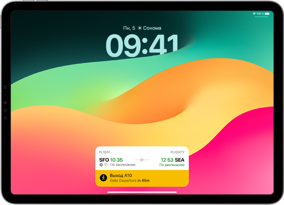 На экране блокировки iPad показан Эфир активности: отслеживается рейс через ресурс для отслеживания рейсов авиакомпании, показаны время вылета и время прибытия и ожидаемый интервал отправления.