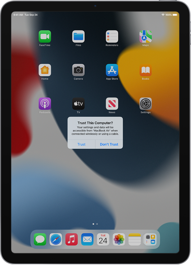 An iPad showing the Trust This Computer? dialog when first connected to a MacBook Pro.