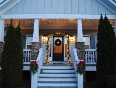 After: The result is a budget-friendly holiday makeover that's a bit reminiscent of a Currier and Ives print. The garland, wreath and swags, all from Trader Joe's, ended up at just under $35. We used icicle lights and lanterns we already owned. An important factor for us: The porch still doesn't feel cluttered.