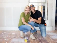 Jenny (L) and Dave (R) Marrs kneel and hold hands in the master bedroom of the home they are remodeling to be a bed and breakfast. Sheetrock dust covers the floor. This home was built in the 1880's and is located in Rogers Arkansas close to downtown and can be seen on Fixer to Fabulous on HGTV.