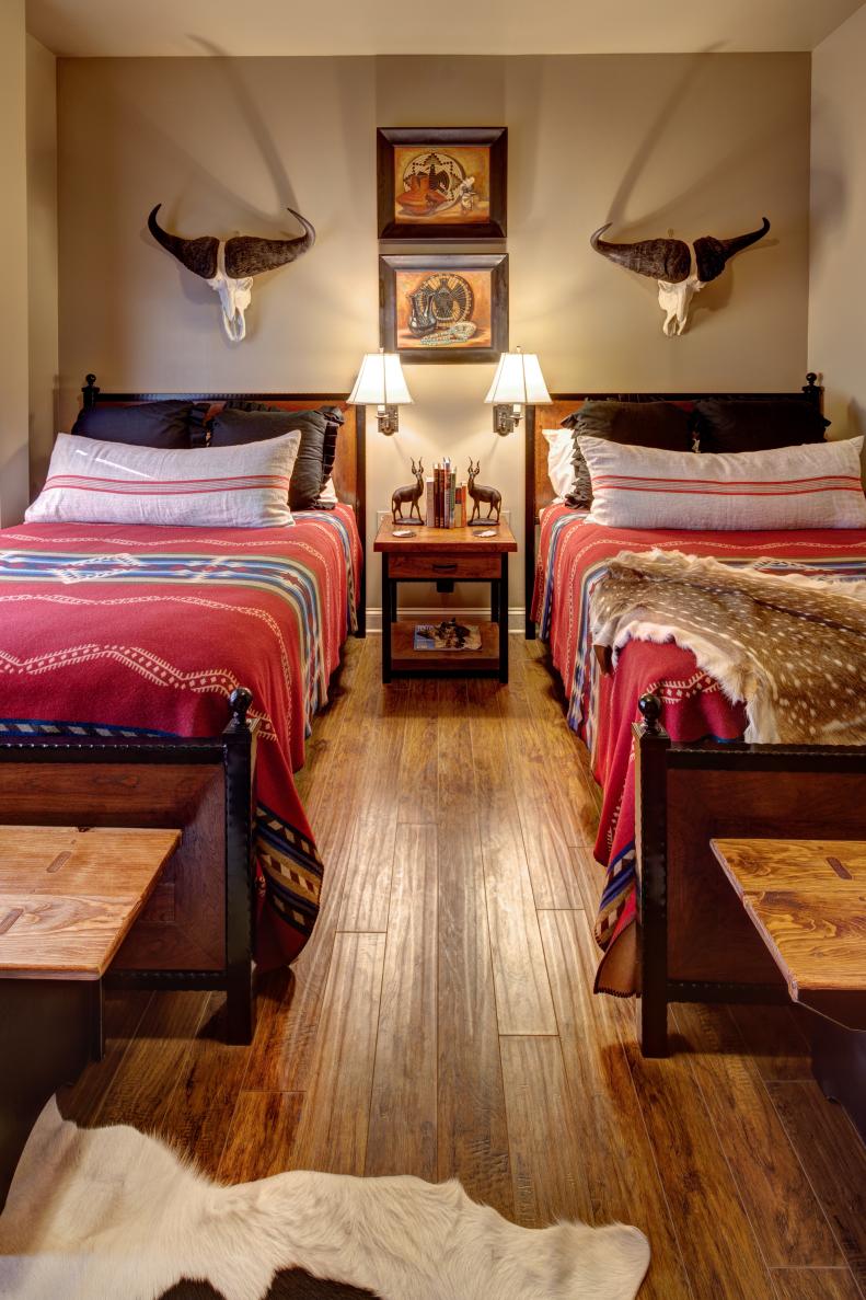 Neutral Southwestern Bedroom With Red Bedding and Mounted Antlers